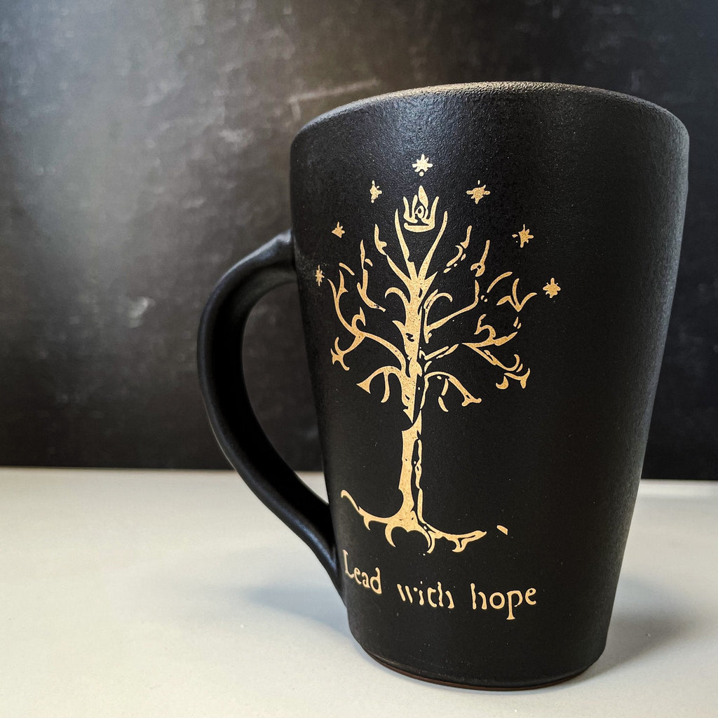 Handcrafted Lord of the Rings ceramic mugs with 22k gold illustrations & motivational texts. Perfect gift for book lovers and fantasy enthusiasts.